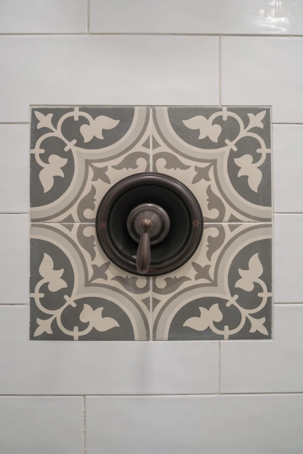 Patterned accent tile around the shower valve