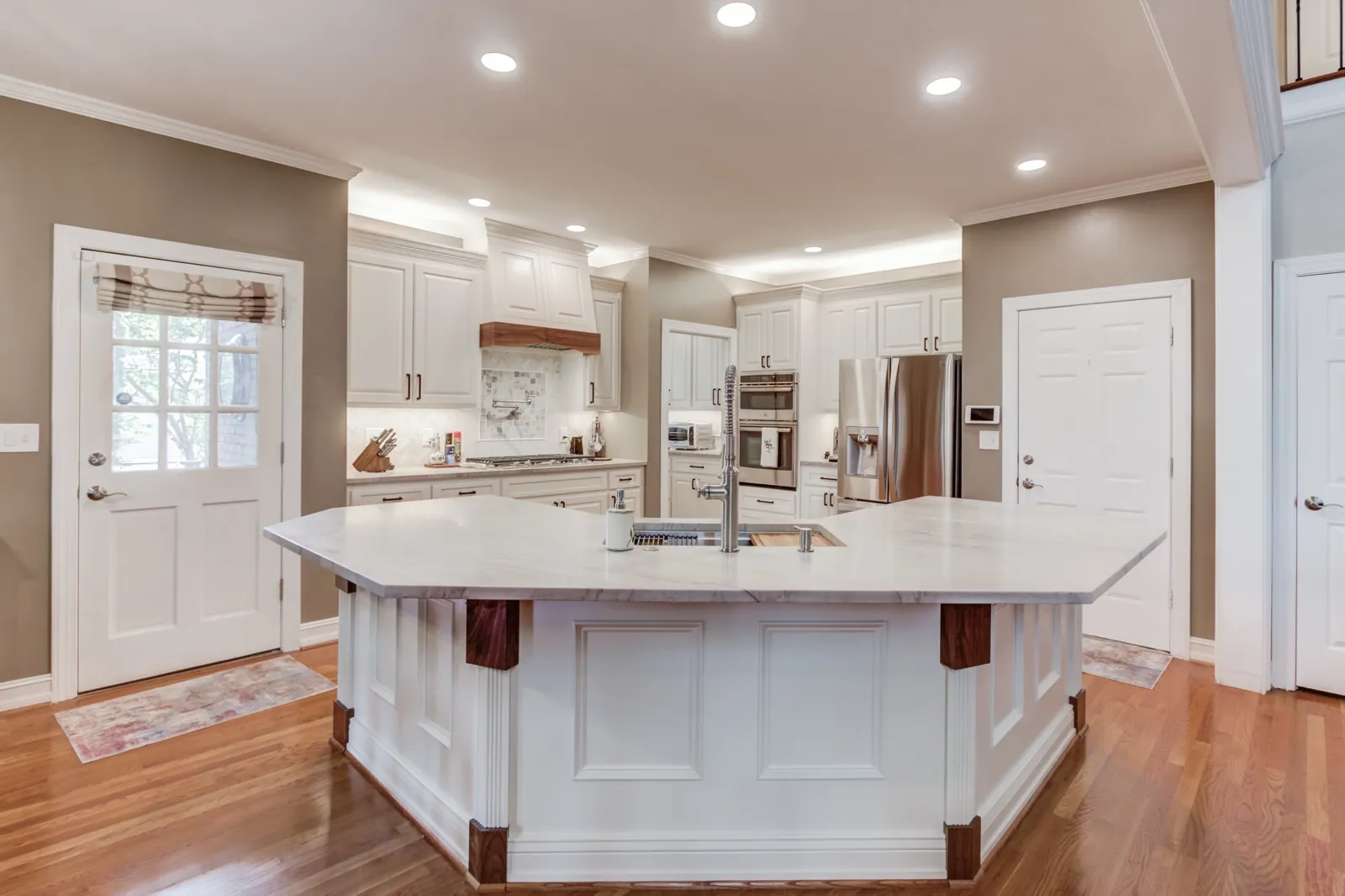 Kitchen remodeling for Alpharetta, GA homeowners: a JWAC kitchen with white cabinets and a large center island