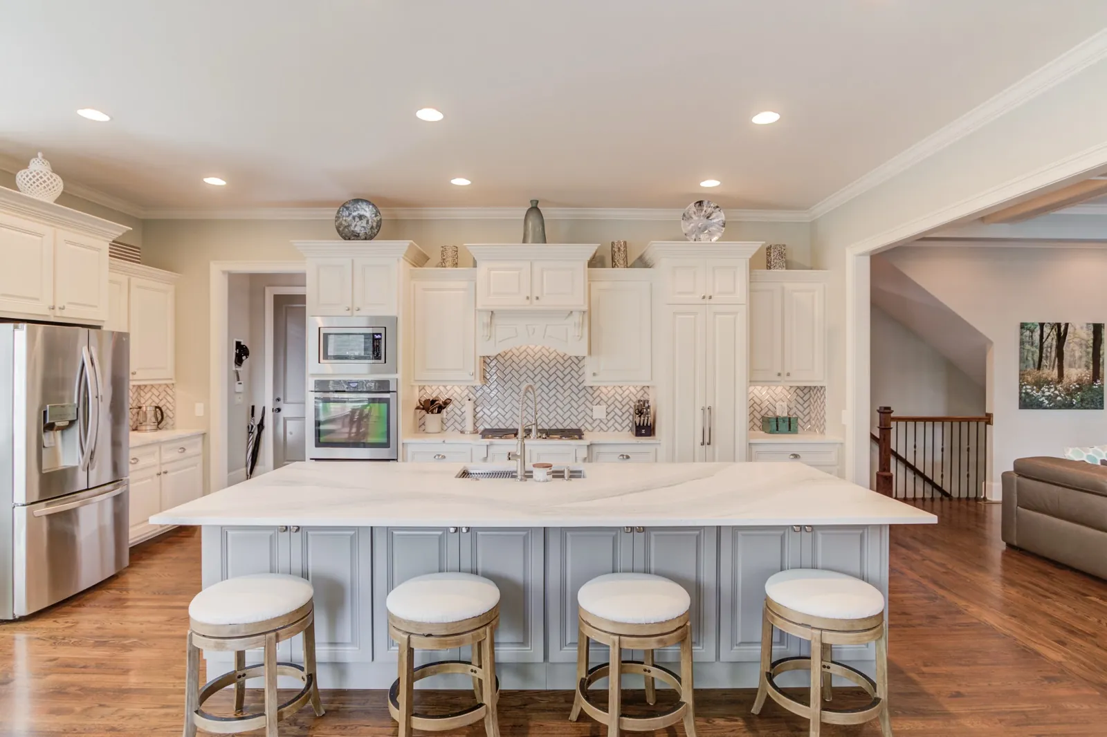 Kitchen remodeling for Cumming, GA homeowners: a JWAC kitchen with white cabinets and a long gray island with seating
