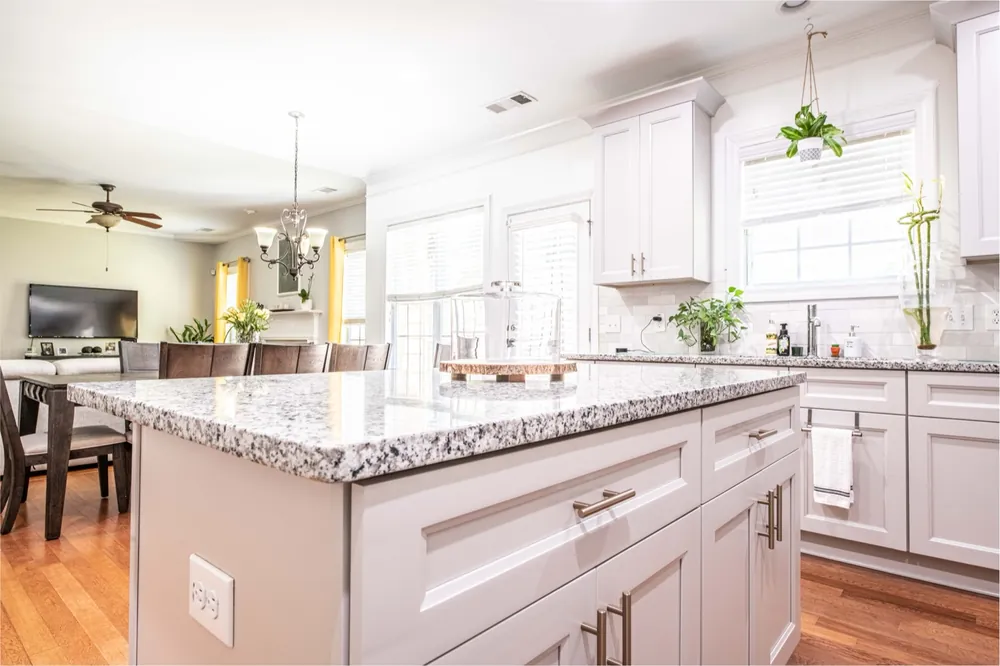 White shaker cabinets with a granite-topped island
